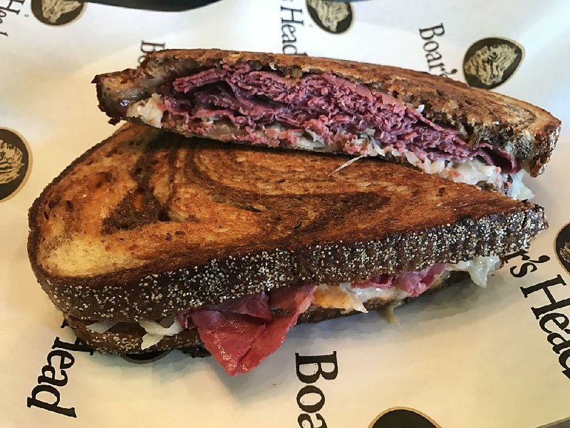 The Reuben Reimagined, with corned beef, Swiss cheese, sauerkraut, sauteed onions and panini sauce on marble rye, is served at Paninis & Company, inside Midtowne Little Rock’s I Love Juice Bar. 