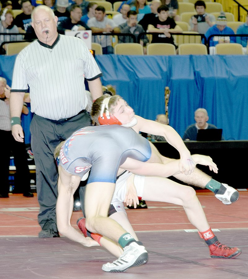 PHOTO BY RICK PECK McDonald County&#8217;s Jake Gerow tries to take down Clayton Singh of Kearney in a 120-pound quarterfinal match at the Missouri Class 3 Wrestling Championships held Feb. 16-18 at the University of Missouri in Columbia. Singh claimed a 3-2 decision and went on to win his third state championship while Gerow finished in fifth place.