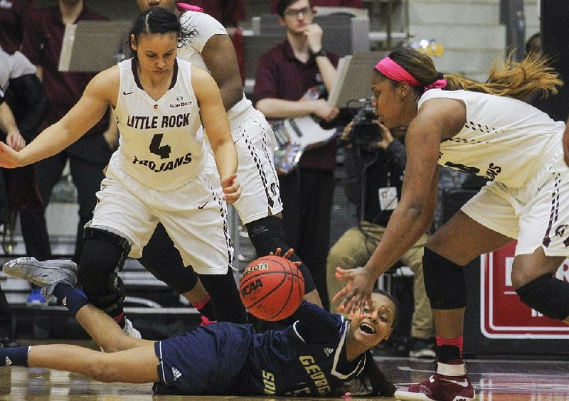 University of Arkansas at Little Rock’s Kaitlyn Pratt (right) chases after a loose ball after Georgia Southern University’s Amira Atwater lost her dribble Thursday during the Trojans’ 57-41 victory over the Eagles at the Jack Stephens Center in Little Rock.