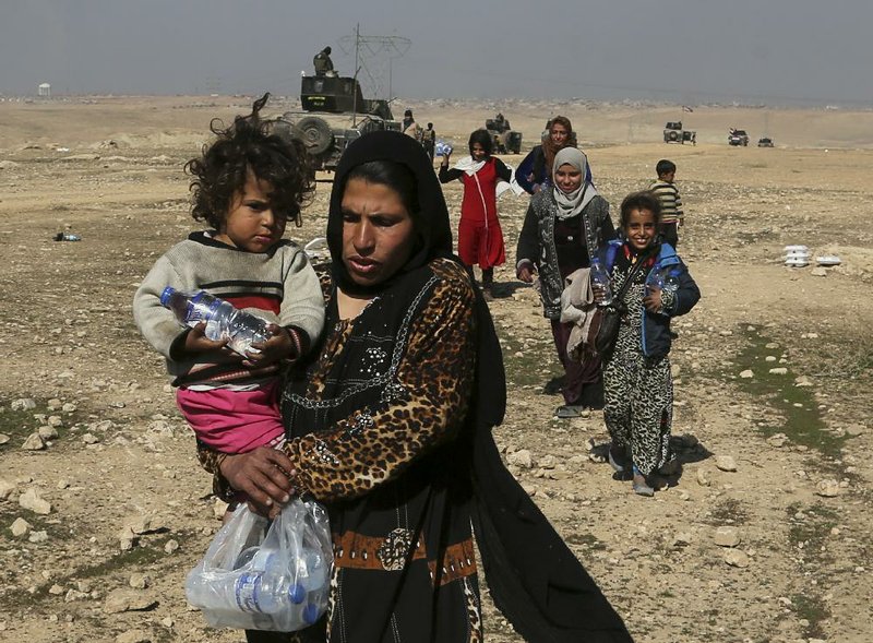 Iraqis flee their homes Thursday during fighting between Iraqi forces and Islamic State militants in western Mosul. 