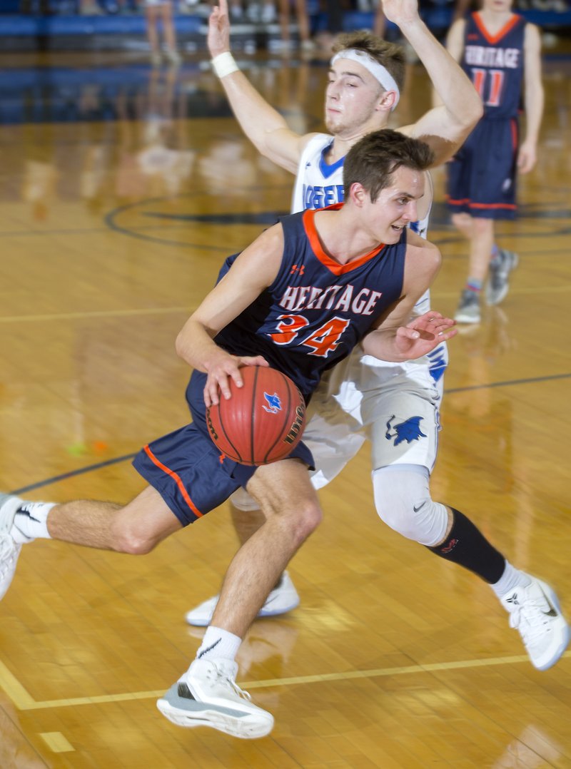 NWA Democrat-Gazette/JASON IVESTER
Rogers Heritage junior Seth Stanley drives around Rogers High senior Jake Benninghoff on Tuesday, Feb. 7, 2017, at Rogers High.
***NOTE: NOT FOR DAILY; FOR FEATURE ON STANLEY***