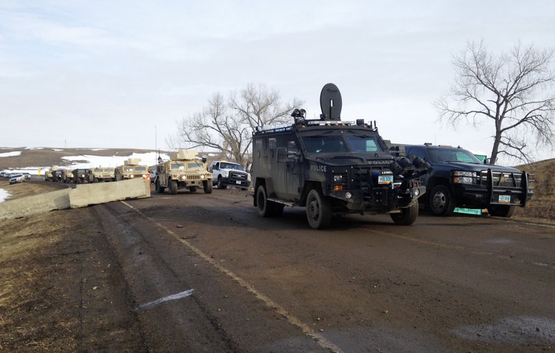 Law enforcement vehicles arrive at the closed Dakota Access pipeline protest camp near Cannon Ball, N.D., Thursday, Feb. 23, 2017, where dozens of people remain. 