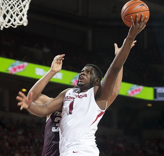 NWA Democrat-Gazette/Jason Ivester COMING THROUGH: Trey Thompson drives to the basket past a Texas A&M defender as Arkansas beats the Aggies 86-77 Wednesday night at Walton Arena in Fayetteville. Arkansas plays road games against Auburn and Florida before its regular-season finale March 4 against Georgia on Senior Day.