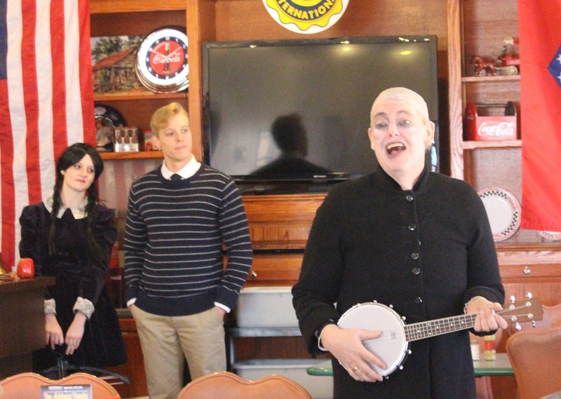 Creepy and Kooky: From left, Hali Pinson, who plays Wednesday Addams, Zachery Gamet, who plays Lucas Beineke and Gary Hall, who plays Uncle Fester Addams, perform a scene from The Addams Family for 
Civitan Club members. Beth James Burns of the Arts Center was the guest speaker for the meeting and brought the actors. 