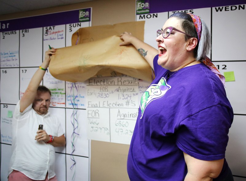 In this file photo from Sept. 8, 2015, Shannon Hix (left), campaign manager, is helped by Laura Phillips, treasurer, as they reveal the results of the passing of the Uniform Civil Rights Administration ordinance at the campaign headquarters of For Fayetteville.