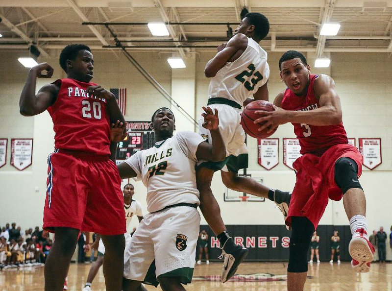 Little Rock Parkview’s Khalil Garland (far right) comes down with a rebound against two Mills defenders as teammate Kevin Cross (20) looks on Friday during the Patriots’ 57-55 overtime victory over the Comets in the championship game of the 5A-Central Conference Tournament in Maumelle.