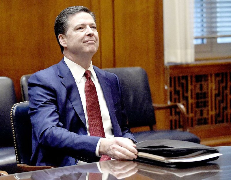 In this Feb. 9, 2017, file photo, FBI Director James Comey waits for the start of a meeting with Attorney General Jeff Session and the heads of federal law enforcement components at the Department of Justice in Washington. 