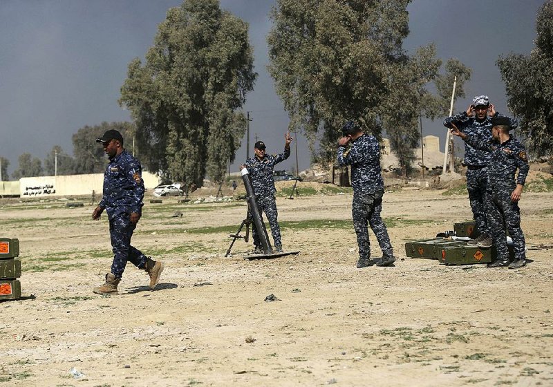 Federal police bomb Islamic State positions Friday as Iraqi security forces take over the international airport in Mosul.