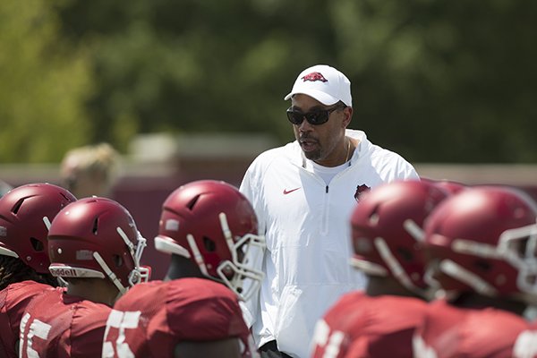 Arkansas linebackers coach Vernon Hargreaves talks to players during warmups on Saturday, Aug. 8, 2015, in Fayetteville. 