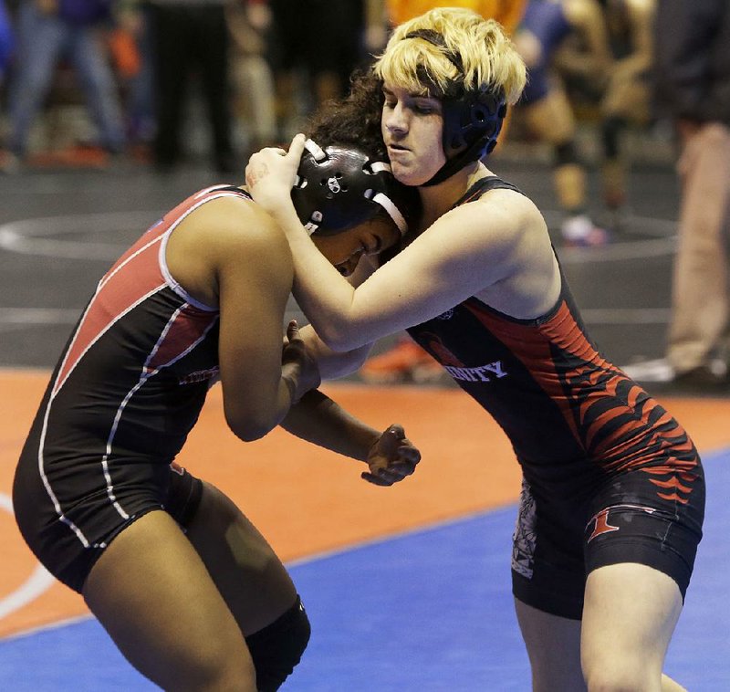 Mack Beggs (right), a transgender boy, won the Texas state girls wrestling title Saturday. State policy calls for students to wrestle against the gender listed on their birth certificates. 