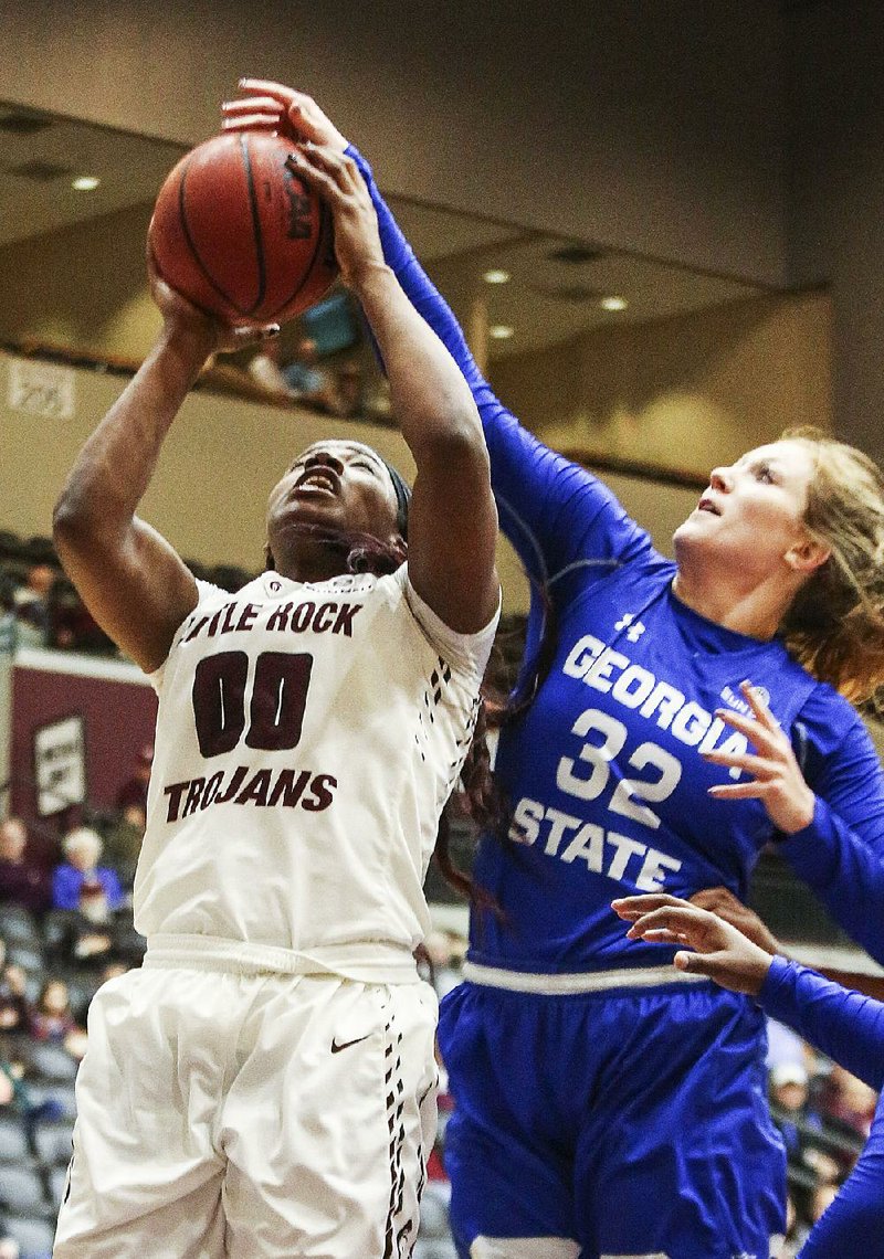 UALR’s Ronjanae DeGray (00) is fouled by Georgia State’s Haley Gerrin (32) during the Trojans’ 52-45 victory Saturday at the Jack Stephens Center. DeGray finished with 14 points for the Trojans.