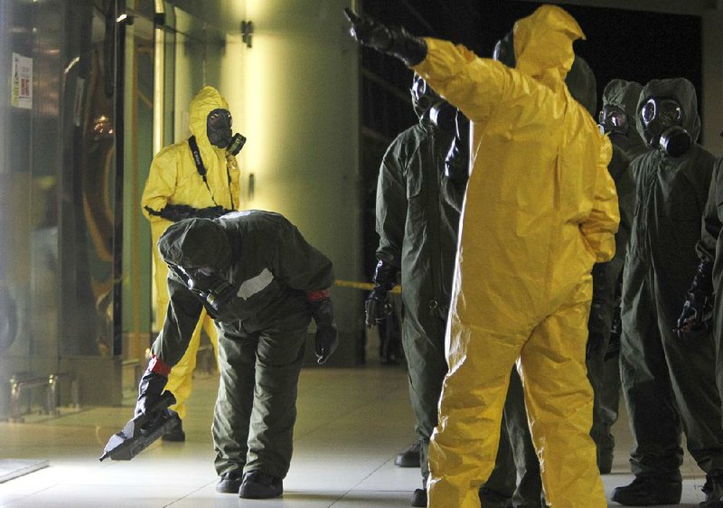 A Malaysian hazardous-materials team scans the area of Kuala Lumpur International Airport today where the half brother of North Korea’s leader was poisoned.