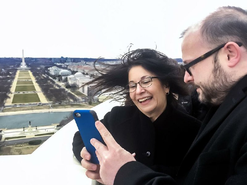 Josie Fernandez, superintendent of Hot Springs National Park, and Ryan Saylor, a spokesman for U.S. Rep. Bruce Westerman, view a video they shot from the top of the U.S. Capitol dome.