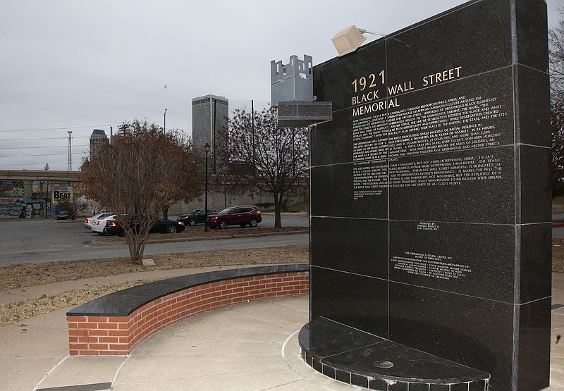 In this Thursday, Dec. 15, 2016 photo, a memorial to Tulsa's Black Wall Street sits outside the Greenwood Cultural Center on the outskirts of downtown Tulsa, Okla. A once-prosperous section of Tulsa that became the site of one of the worst race riots in American history is attempting to remake itself again after decades of neglect. Black leaders want to bring 100 new companies to the former Black Wall Street in north Tulsa by 2021, the 100th anniversary of its fall. (AP Photo/Sue Ogrocki)