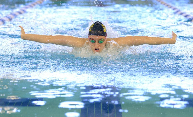 Luciana Thomas of Haas Hall Academy swims in the girls’ 100-yard butterfly Saturday during the Class 1A-5A Arkansas State Swimming and Diving Championships at the Bentonville Community Center. Thomas won the event with a time of 57.11 seconds.