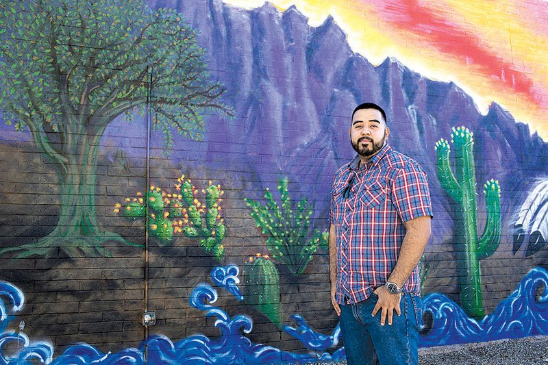 Juan Rodriguez, 24, stands for a photograph at Mesa Community College in Mesa, Ariz., earlier this month. Rodriguez has become eligible for a mortgage, but the current political climate about immigration has made him wary of buying a home. 