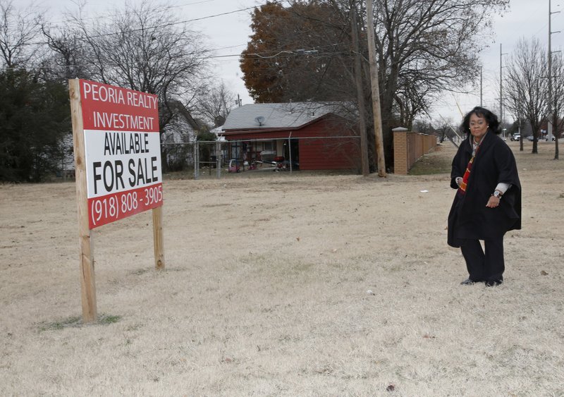 Donna Jackson, NorthTulsa100 executive director, walks through a vacant lot for sale in north Tulsa in late December. 