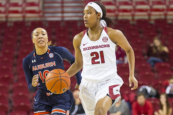 Arkansas' Devin Cosper dribbles up court as Auburn's Brandy Montgomery follows during a game Sunday, Feb. 26, 2017, in Fayetteville. 