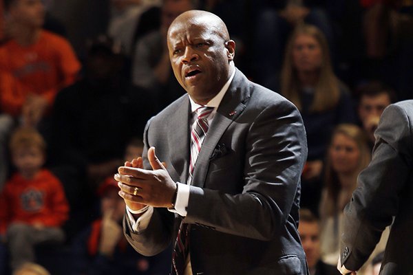 Arkansas coach Mike Anderson claps after a score by his team against Auburn during the first half of an NCAA college basketball game Saturday, Feb. 25, 2017, in Auburn, Ala. (AP Photo/Todd J. Van Emst)