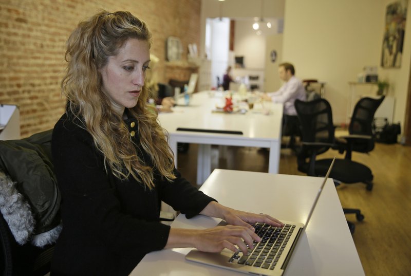Ashley Breinlinger, a senior vice president at BOCA Communications, works at her office desk in San Francisco earlier this month. 