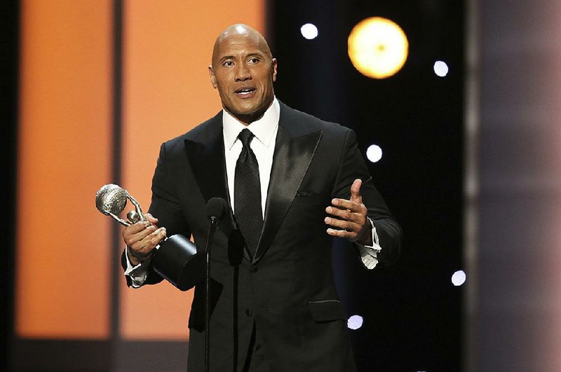 Dwayne Johnson accepts the award for entertainer of the year at the 48th annual NAACP Image Awards at the Pasadena Civic Auditorium on Saturday, Feb. 11, 2017, in Pasadena, Calif. 