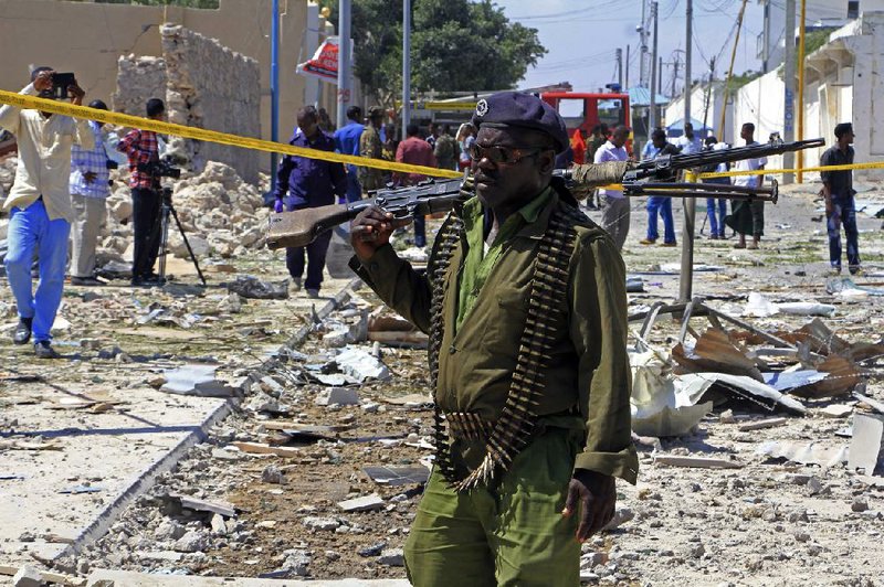 A Somali soldier patrols the area of a suicide car-bomb attack in Mogadishu, Somalia, in January.
