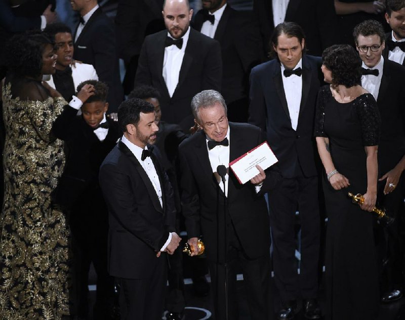 Presenter Warren Beatty shows the envelope with the actual winner for best picture as host Jimmy Kimmel (left) looks on at Sunday’s Academy Awards at the Dolby Theatre in Los Angeles.