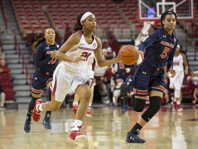 Devin Cosper (21) drives to the basket on a fastbreak as Emari Jones (5) is behind her from Auburn at Bud Walton Arena, Fayetteville, AR, Sunday, February 26, 2017. 