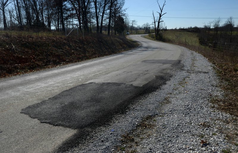 Patches can be seen in the pavement Friday along Stoney Point Road in eastern Benton County. GreenbergFarrow Architecture is doing a survey of paved roads in the county, which will be used to produce a map with video of damaged areas.