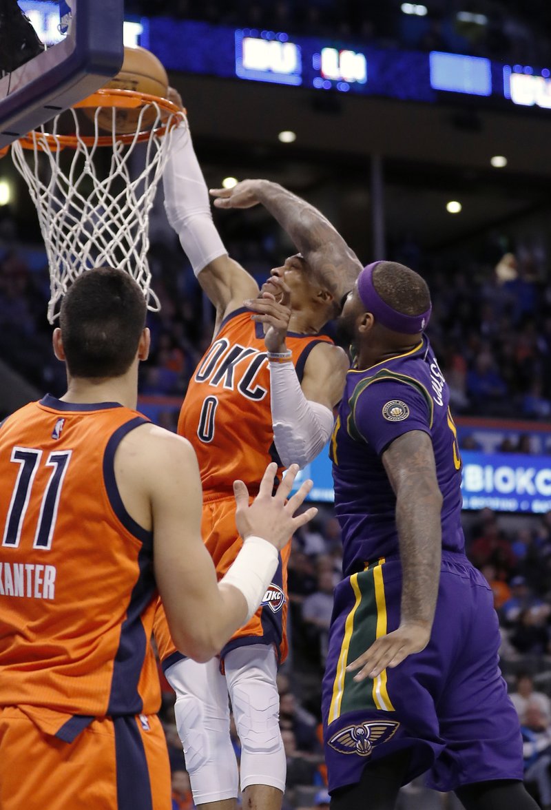 Oklahoma City Thunder guard Russell Westbrook (0) is fouled by New Orleans Pelicans forward DeMarcus Cousins (0) during the second half of an NBA basketball game in Oklahoma City, Sunday, Feb. 26, 2017. Oklahoma City won 118-110. 