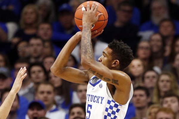 Kentucky's Malik Monk, right, shoots over the defense Florida's Canyon Barry during the second half of an NCAA college basketball game, Saturday, Feb. 25, 2017, in Lexington, Ky. (AP Photo/James Crisp)