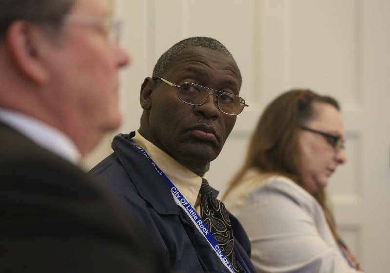 Freddie Davis and Kathleen Countryman, both neighborhood resource specialists in Little Rock, listen to Mayor Mark Stodola on Monday at the Willie Hinton Neighborhood Resource Center during a forum on crime.