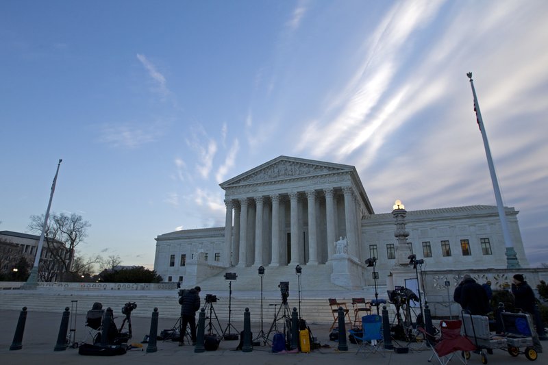 FILE - In this Feb. 1, 2107 file photo, members of the media gather outside the Supreme Court in Washington. With a nod to the importance of social media in American life, the Supreme Court signaled Monday, Feb. 27, 2017, it could strike down a North Carolina law that bars convicted sex offenders from Facebook, Twitter and other popular sites.