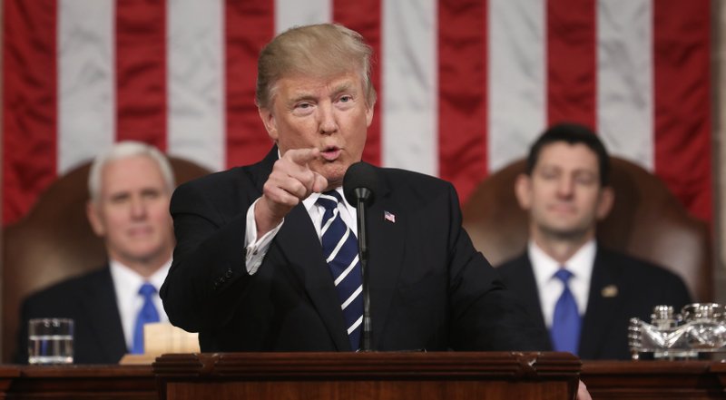 President Donald Trump addresses a joint session of Congress on Capitol Hill in Washington, Tuesday, Feb. 28, 2017. Vice President Mike Pence and House Speaker Paul Ryan of Wis. listen. (Jim Lo Scalzo/Pool Image via AP)
