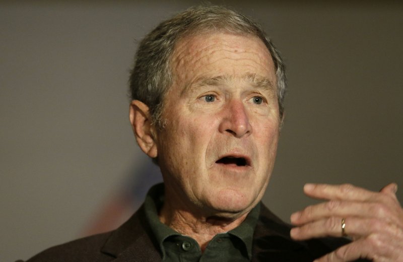 Former President George W Bush speaks during a preview of an exhibition of his paintings of U.S. military veterans in Dallas, Tuesday, Feb. 28, 2017. 