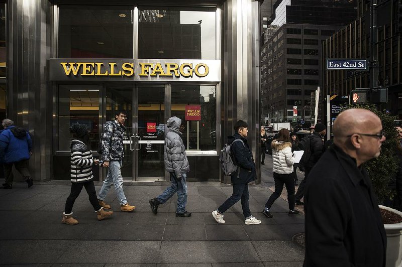A Wells Fargo & Co. bank branch is shown in New York in January. U.S. banks earned $43.7 billion in the fourth quarter, up from $40.8 billion a year ago, the FDIC reported on Tuesday. 