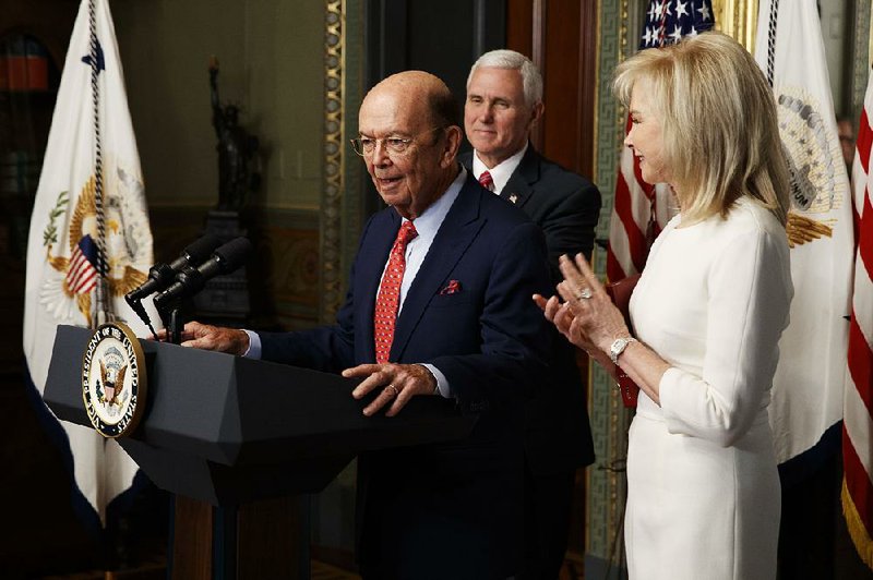 Wilbur Ross speaks Tuesday after being sworn in by Vice President Mike Pence as commerce secretary. At right is his wife, Hilary Geary Ross.