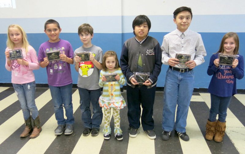 Photo by Susan Holland Youths of the Month for each month were honored at the annual Boys and Girls Club banquet Tuesday, Feb. 7, at the Gravette club room. Honorees for each month were introduced and presented plaques and $10 Walmart gift certificates. Pictured with their plaques are 2016 Youths of the Month who attended from Decatur, Alexis Standefer (left), Aleck Echevarria, Joshua Crook, Esme Gibson, Cam&#8217;Ron Vang, Poli Xiong and Bailey Leonard.