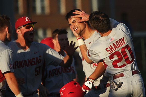 Arkansas first baseman Jordan McFarland (13) is congratulated by Carson Shaddy (20) and Lucas Krull (51) after hitting a go-ahead home run in the seventh inning of a win over Louisiana Tech on Wednesday, March 1, 2017, in Ruston, La. The Razorbacks came back to beat the Bulldogs 13-10 after trailing by nine runs. 