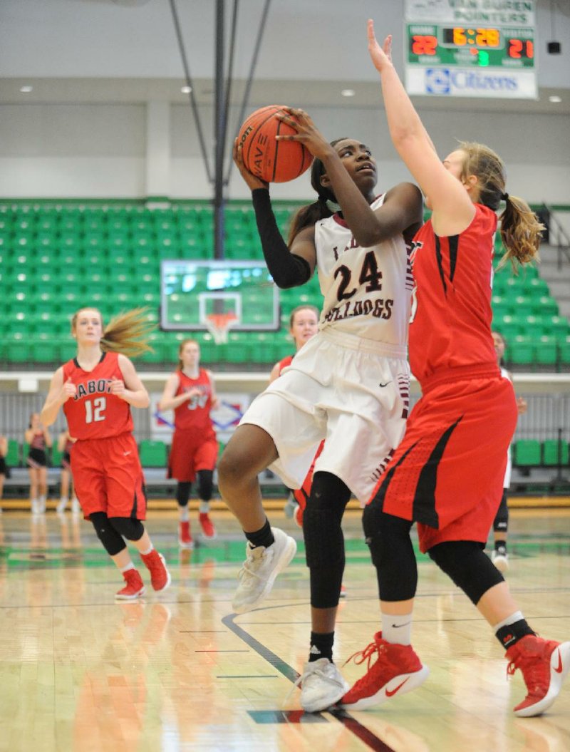 Springdale forward Marquesha Davis looks to shoot over Cabot defender Camryn Harmon during the Class 7A girls state basketball tournament Wednesday at Van Buren. Davis finished with 18 points and 10 rebounds to lead the Lady Bulldogs to a 49-46 overtime victory.