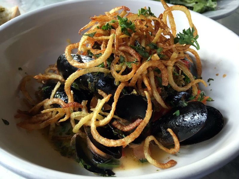 A dozen steamed mussels at Ciao Baci come in a parsley-garlic broth, topped with crisp-fried potato strings. 