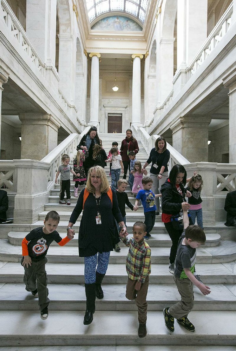 Teachers lead a group of pre-kindergarten pupils from the Cabot School District through the state Capitol on Wednesday.