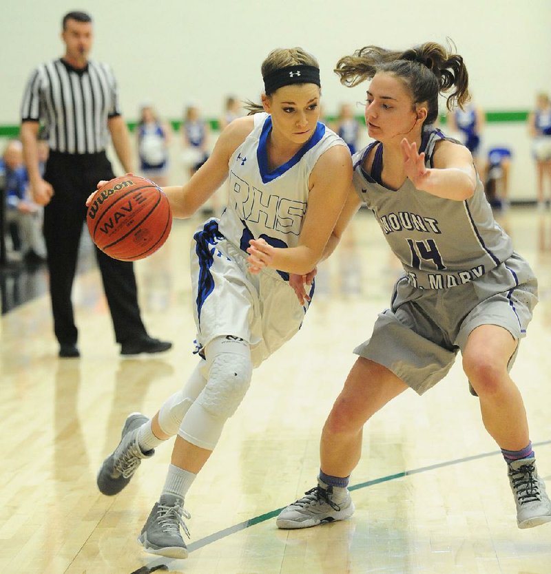 Rogers guard Maddi McKinney (left) is cut off by Mount St. Mary defender Payton Grace (right) during the Class 7A girls state basketball tournament Thursday at Van Buren. The Lady Mounties never trailed in rolling to a 51-25 victory.