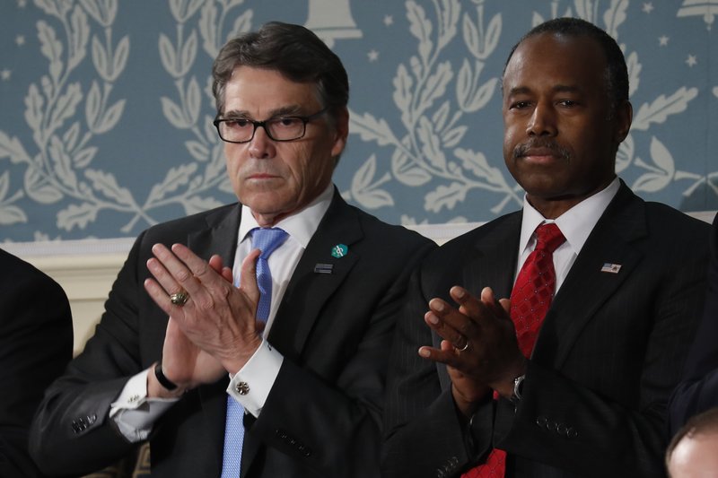 Energy Secretary Rick Perry, left, and Housing and Urban Development Secretary-designate Ben Carson applaud on Capitol Hill in Washington, Tuesday, Feb. 28, 2017, before President Donald Trump's address to a joint session of Congress. 