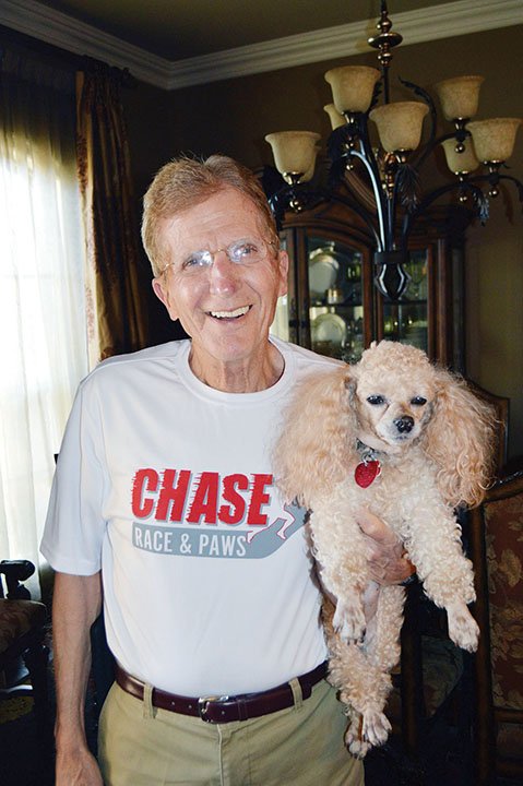 Don Potter of Conway, founder of Chase Race and Paws, holds his dog Killer, who participates in the race each year. The race was created in 2006 to honor the memory 
of Potter’s 13-year-old son, who died March 12, 2005. The race/walk is scheduled to kick off at 8 a.m. Saturday at Simon Park on Front Street in downtown Conway.