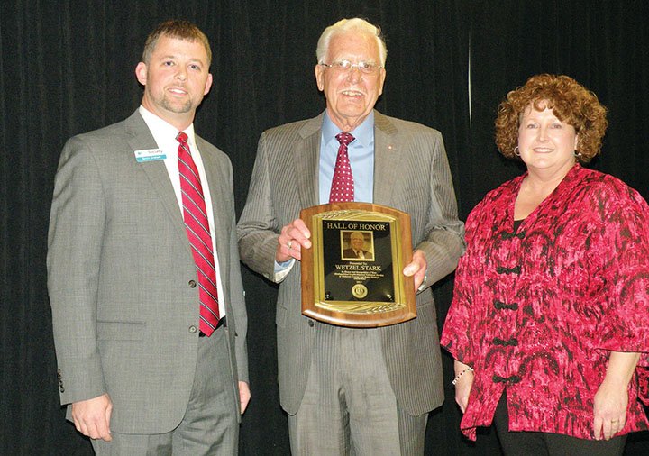 Wetzel Stark of Heber Springs, center, accepts the Heber Springs Area Chamber of Commerce Hall of Honor Award. Presenting the award are Brett Graham, 2017 president of the chamber’s board of directors, and Julie Murray, chamber executive director.