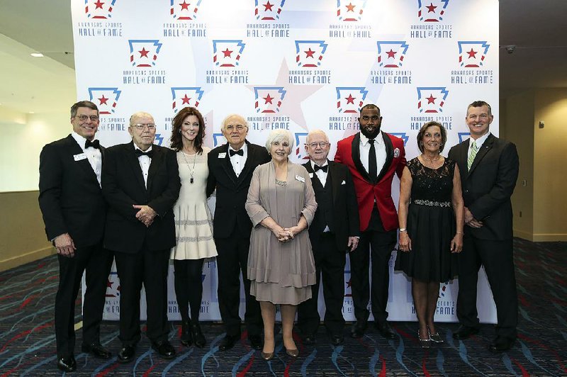 The Arkansas Sports Hall of Fame inducted nine new members Friday during a ceremony at the Statehouse Convention Center in Little Rock. On hand for the ceremony were (from left) Tim Langford; Charlie Dearman; Charlotte Jones Anderson; Jim Rasco; Utanah Williams, wife of the late Dave Williams; Wally Hall; Darren McFadden; Tammy Jackson, wife of the late Larry Jackson; and Sean Rochelle.