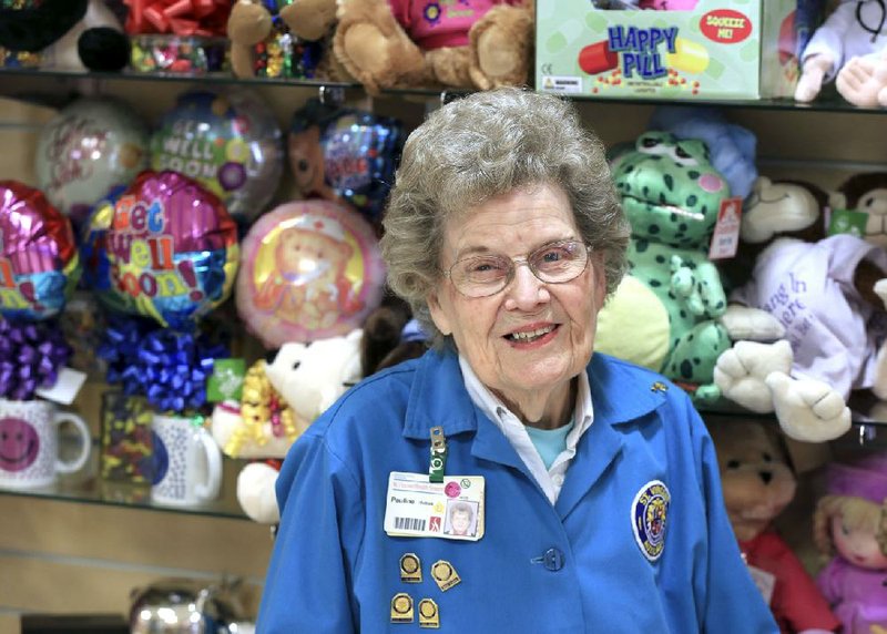 Pauline Helton, 95, volunteers every week at Lori’s Gifts at CHI St. Vincent North. Surrounded by toy animals and balloons, she says the job and the Lord “keep me going.” 