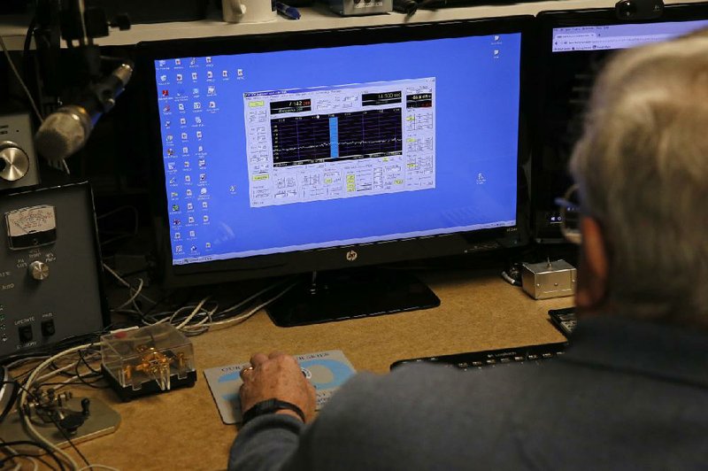 Lifelong ham radio operator and expert tinkerer Tom Thompson, looks at a representation of radio waves on his computer last month, inside his basement home office, where he operates a ham radio and other devices, in Boulder, Colo.
