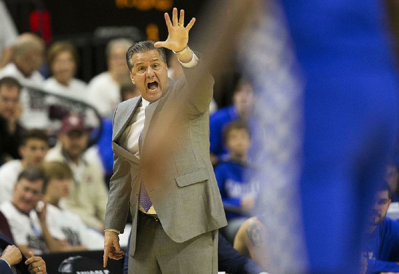 Kentucky Coach John Calipari tries to get the attention of his team during a 71-63 victory over Texas A&M in College Station, Texas.